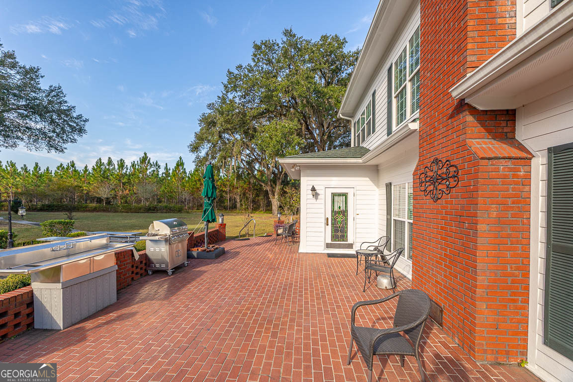 300 Elliott Road Waynesville, GA 31566 - Photo 16 of 89 a view of a house with pool table and chairs in a patio