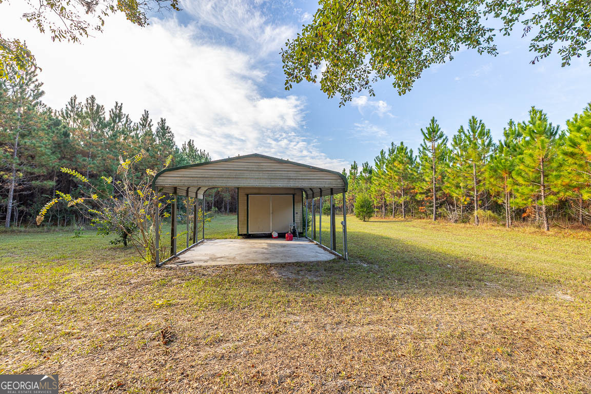 300 Elliott Road Waynesville, GA 31566 - Photo 20 of 89 a front view of a house with garden