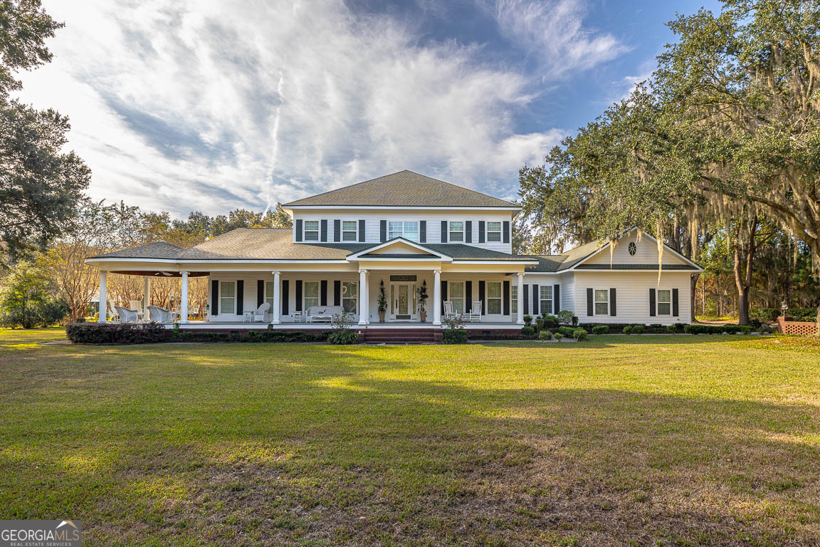 300 Elliott Road Waynesville, GA 31566 - Photo 2 of 89 a front view of a house with swimming pool