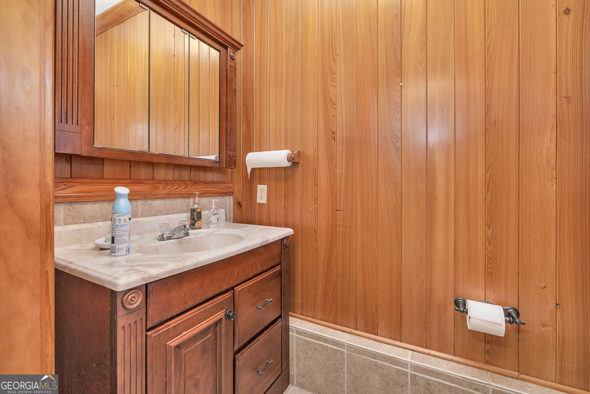 300 Elliott Road Waynesville, GA 31566 - Photo 28 of 89 a bathroom with a sink a vanity and a mirror
