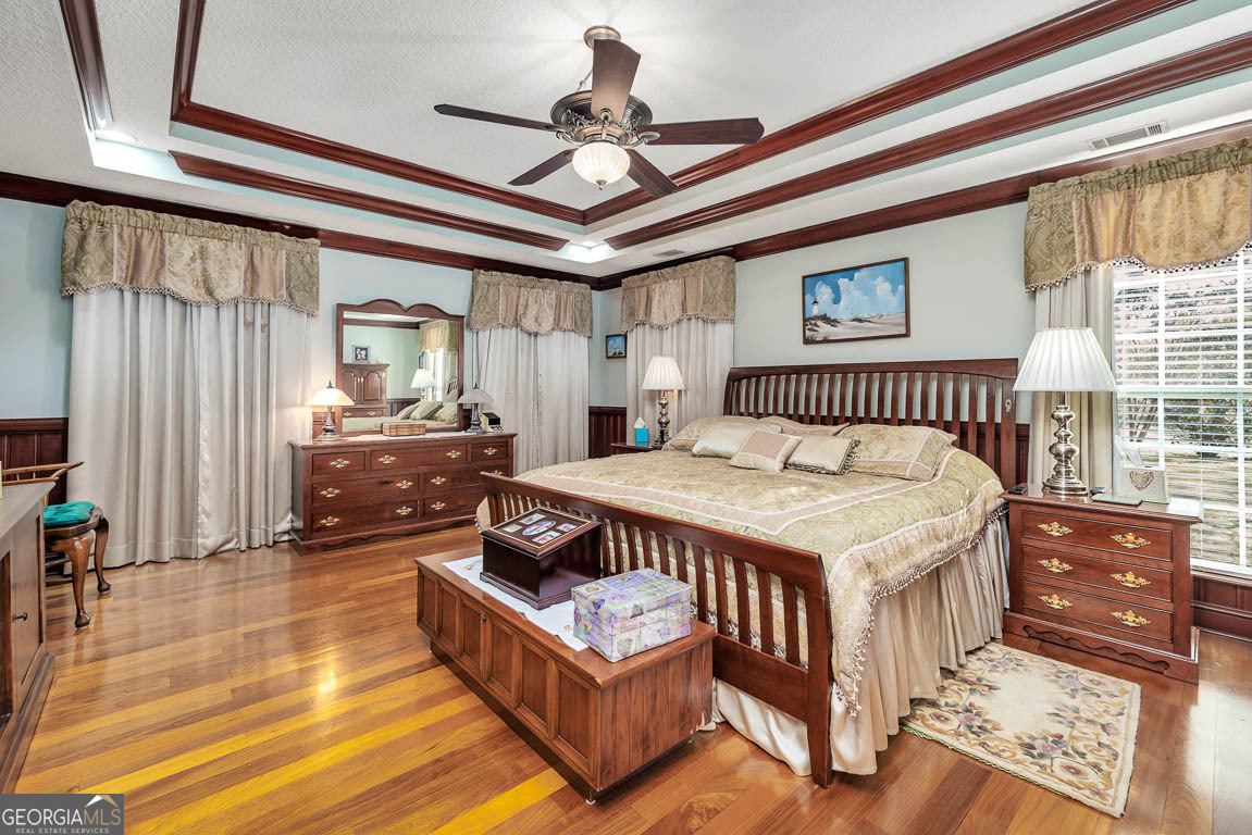 300 Elliott Road Waynesville, GA 31566 - Photo 38 of 89 a bedroom with a bed mirror and a window