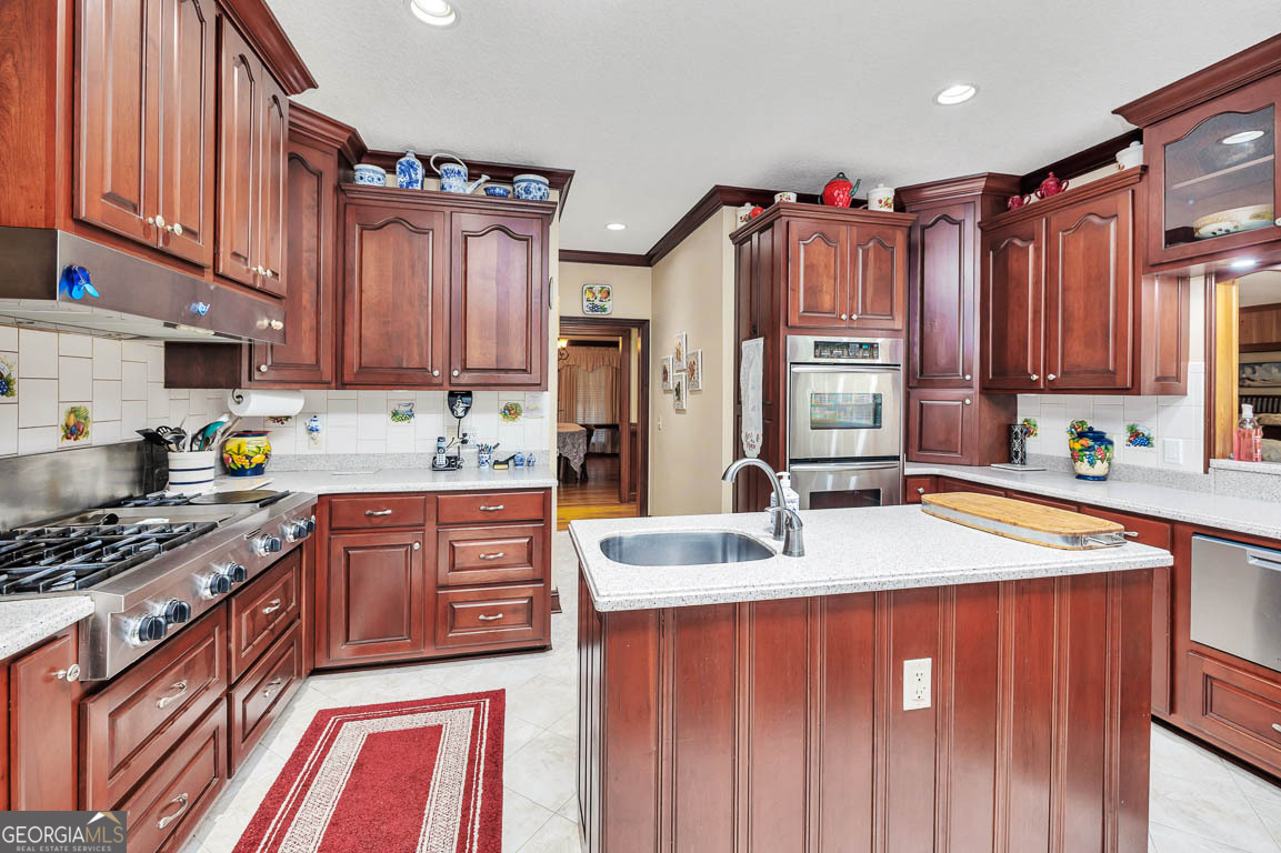 300 Elliott Road Waynesville, GA 31566 - Photo 45 of 89 a kitchen with stainless steel appliances granite countertop a sink stove and refrigerator