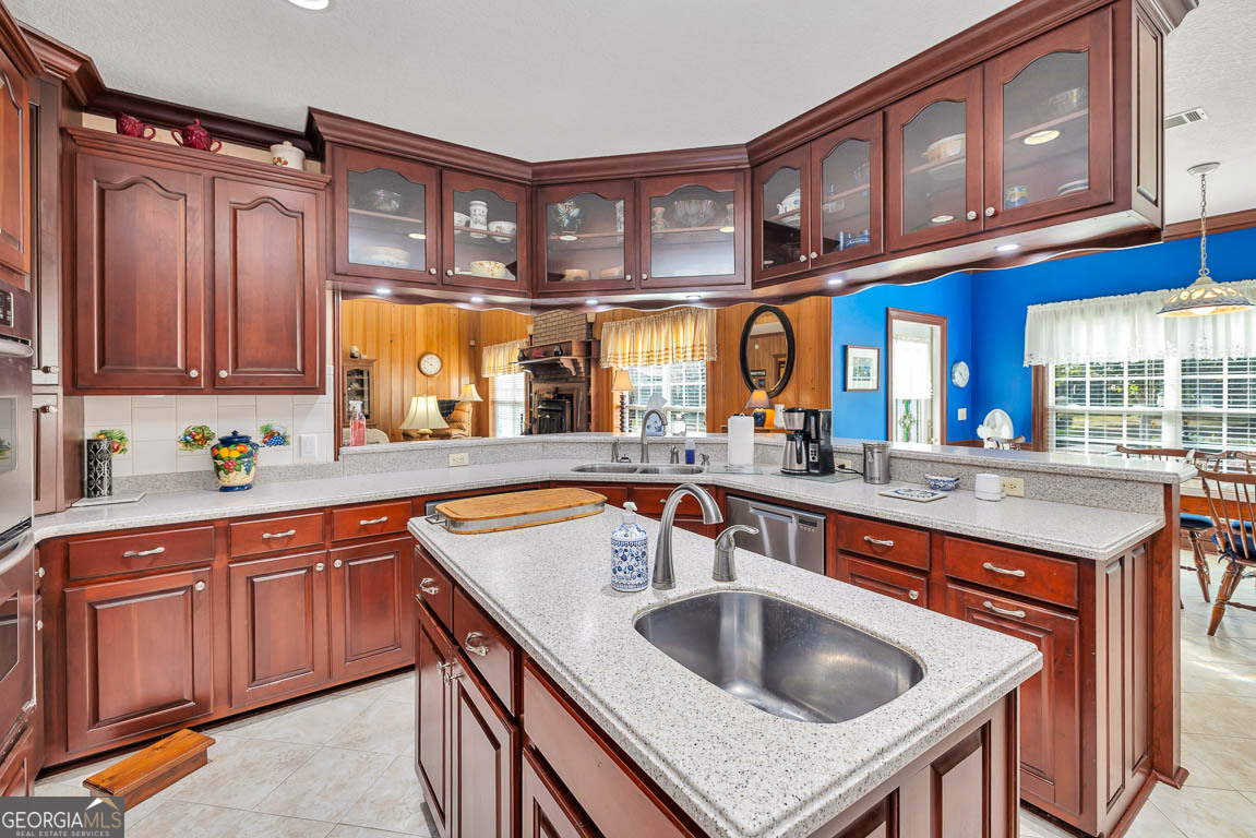 300 Elliott Road Waynesville, GA 31566 - Photo 47 of 89 a kitchen with stainless steel appliances granite countertop a sink and cabinets
