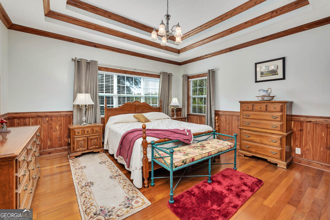 300 Elliott Road Waynesville, GA 31566 - Photo 57 of 89 a bedroom with bed and wooden floor