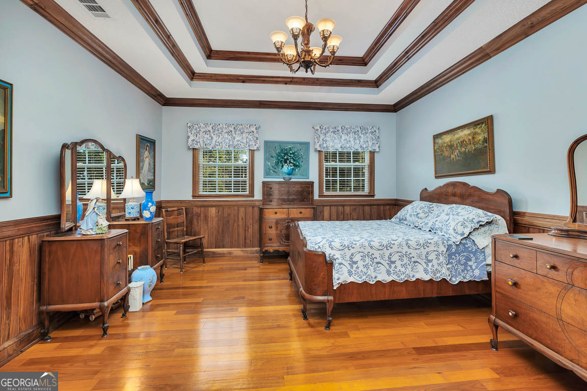 300 Elliott Road Waynesville, GA 31566 - Photo 60 of 89 a bedroom with a bed and wooden floors