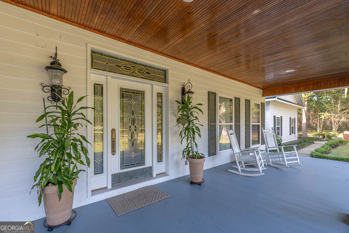 300 Elliott Road Waynesville, GA 31566 - Photo 7 of 89 a view of a patio with table and chairs and potted plants