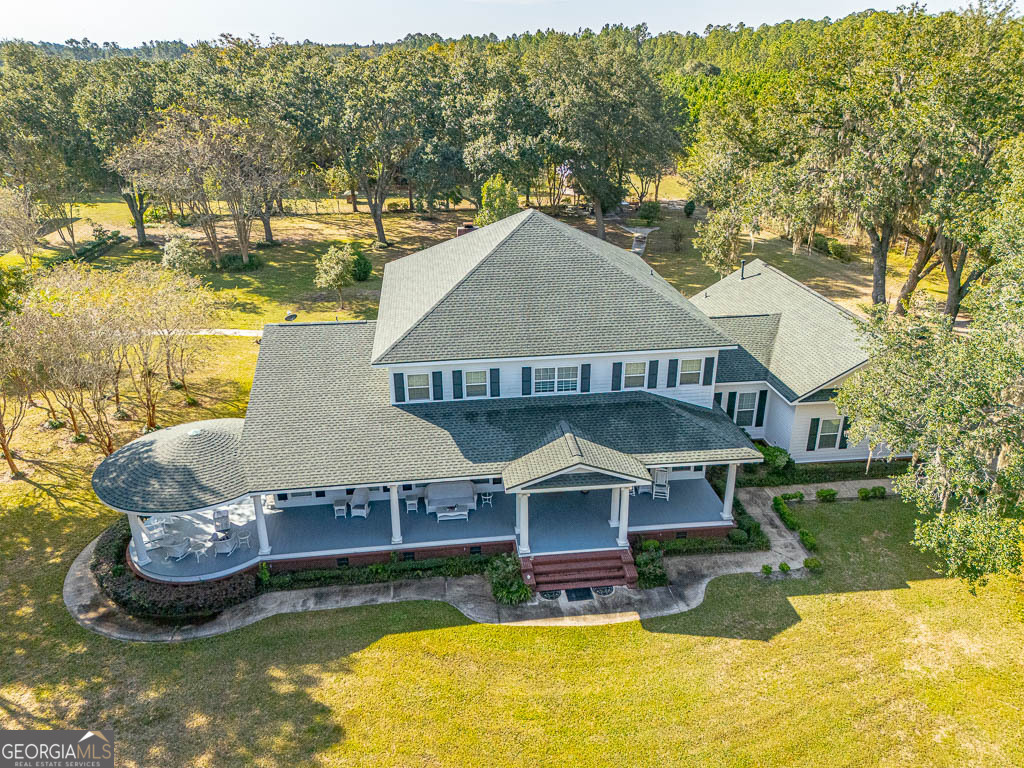 300 Elliott Road Waynesville, GA 31566 - Photo 80 of 89 an aerial view of a house with swimming pool and large trees