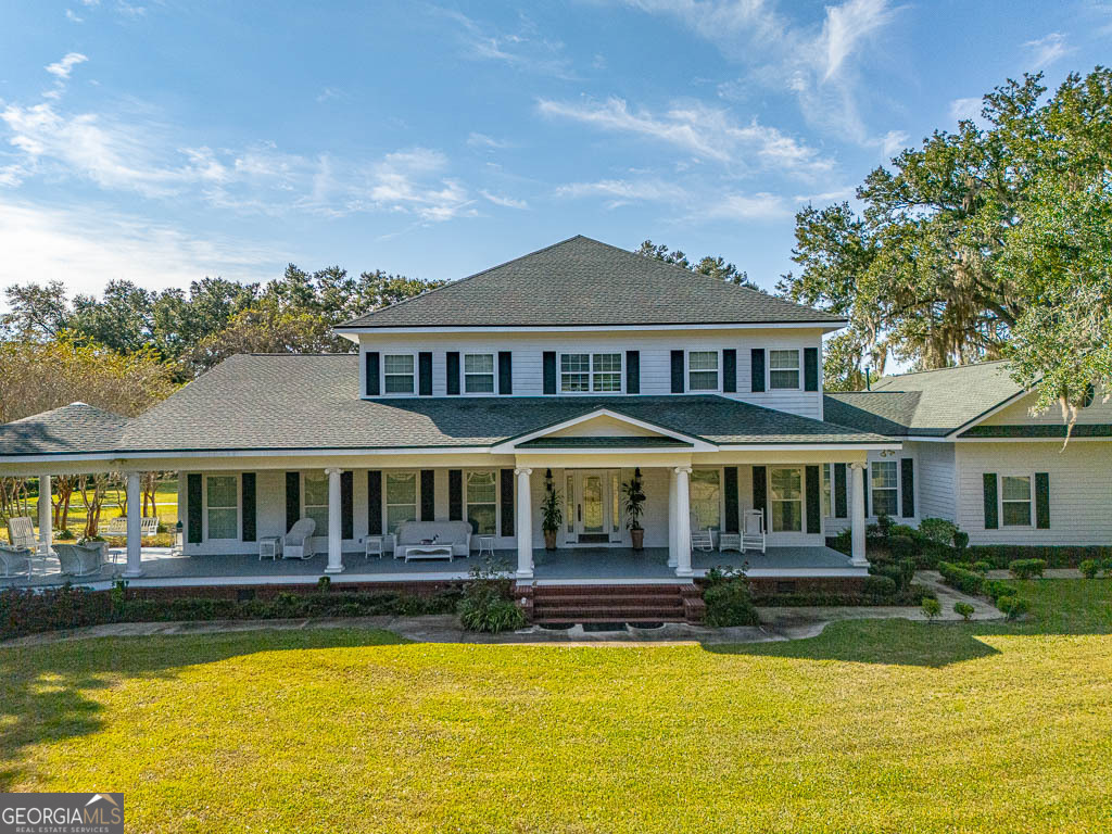 300 Elliott Road Waynesville, GA 31566 - Photo 82 of 89 a front view of a house with swimming pool and porch