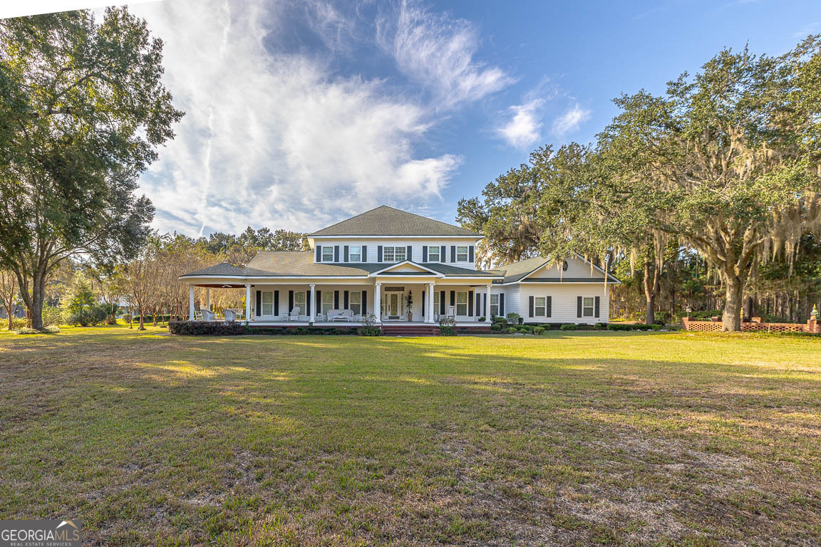 300 Elliott Road Waynesville, GA 31566 - Photo 86 of 89 a front view of a house with a garden and trees