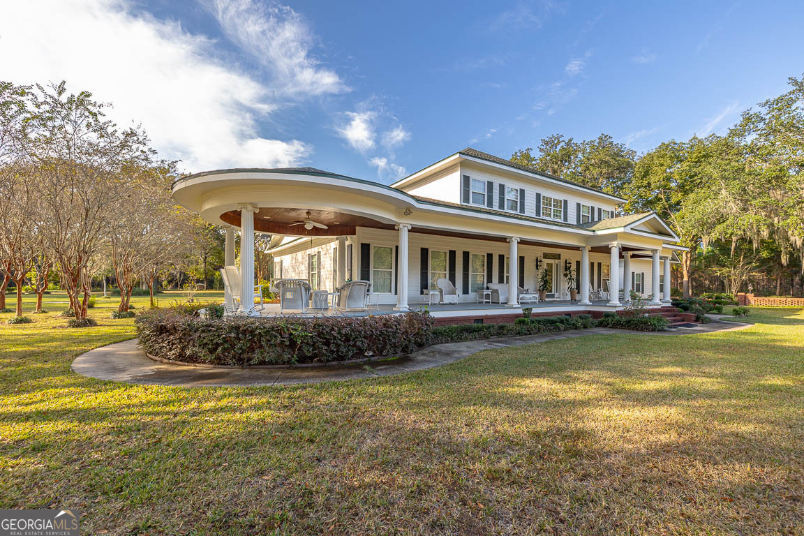 300 Elliott Road Waynesville, GA 31566 - Photo 89 of 89 a front view of a house with a garden and swimming pool