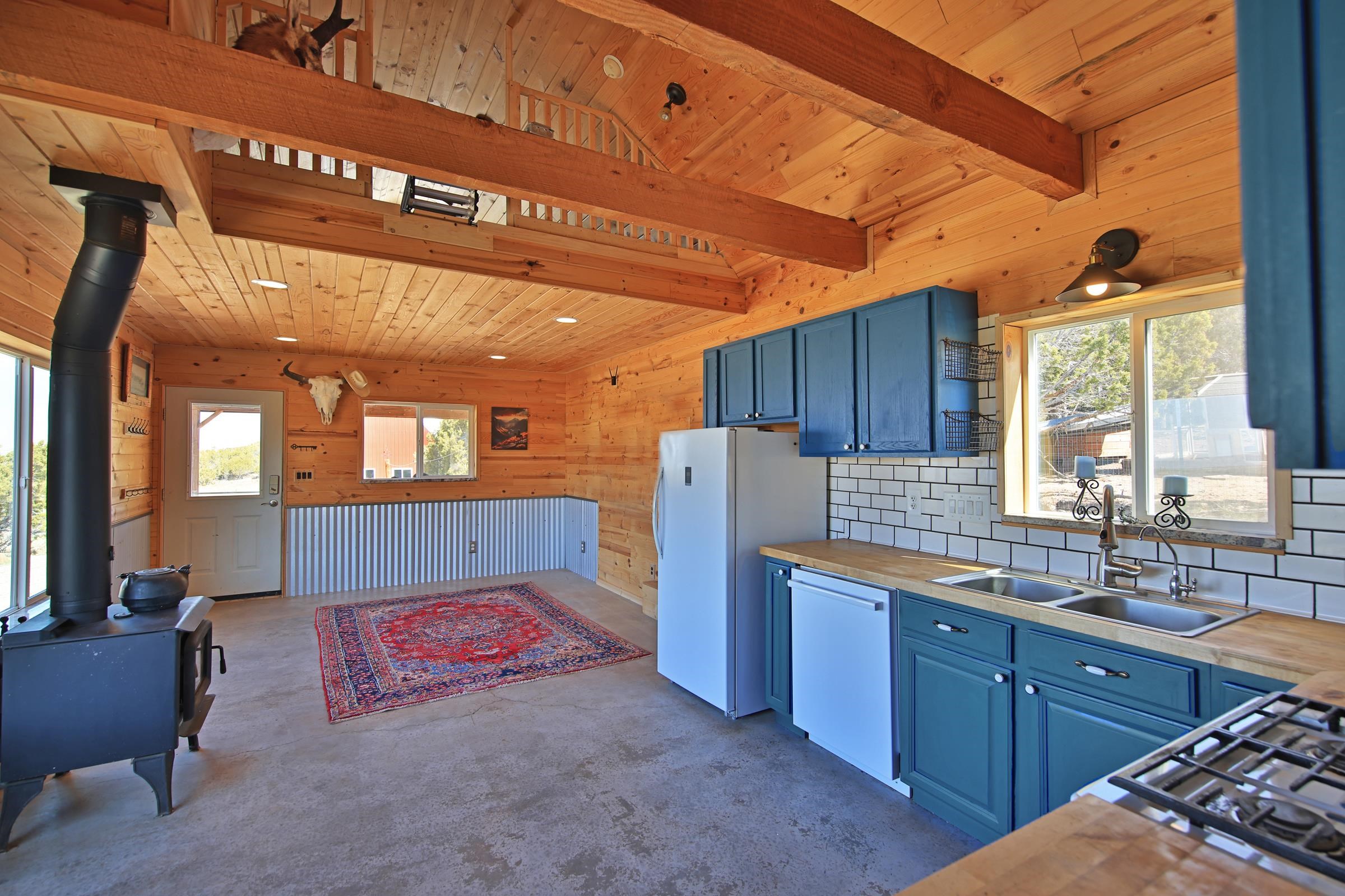 56001 KK Road Molina, CO 81646 - Photo 11 of 42 a kitchen with stainless steel appliances kitchen island granite countertop a refrigerator and wooden cabinets