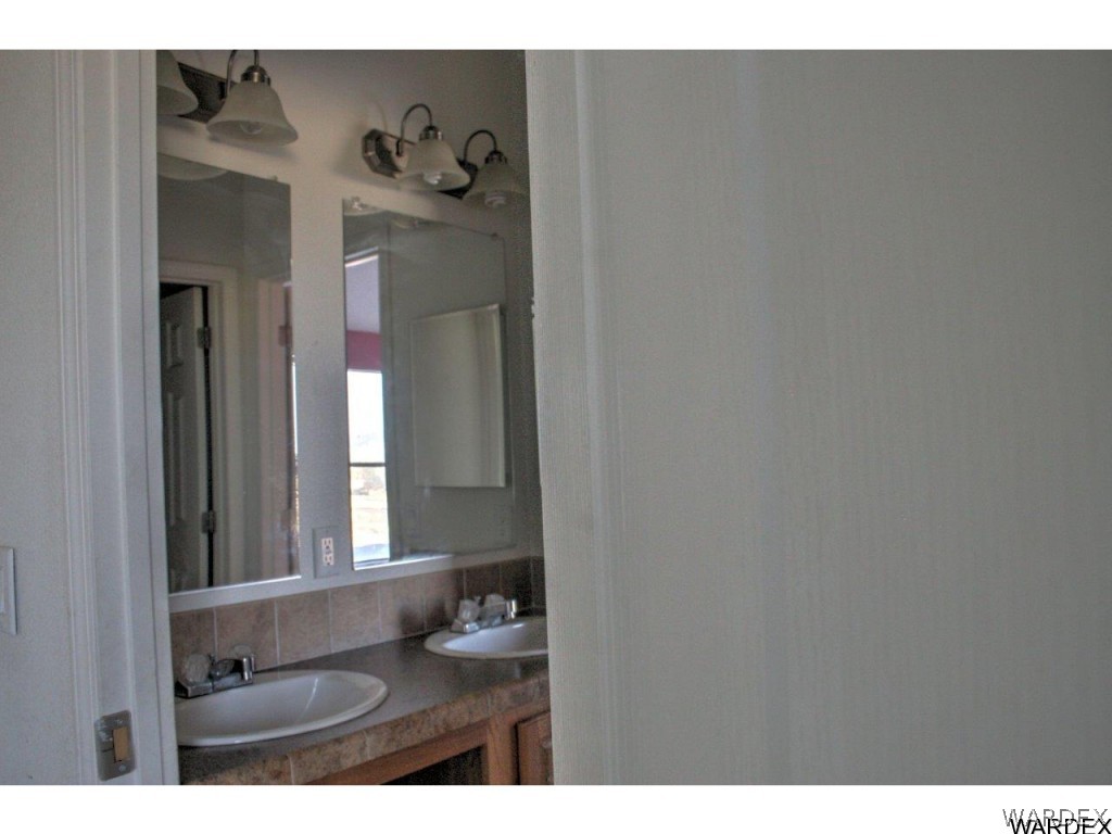 3969 Elfrida Road Golden Valley, AZ 86413 - Photo 13 of 29 a bathroom with a sink and a mirror