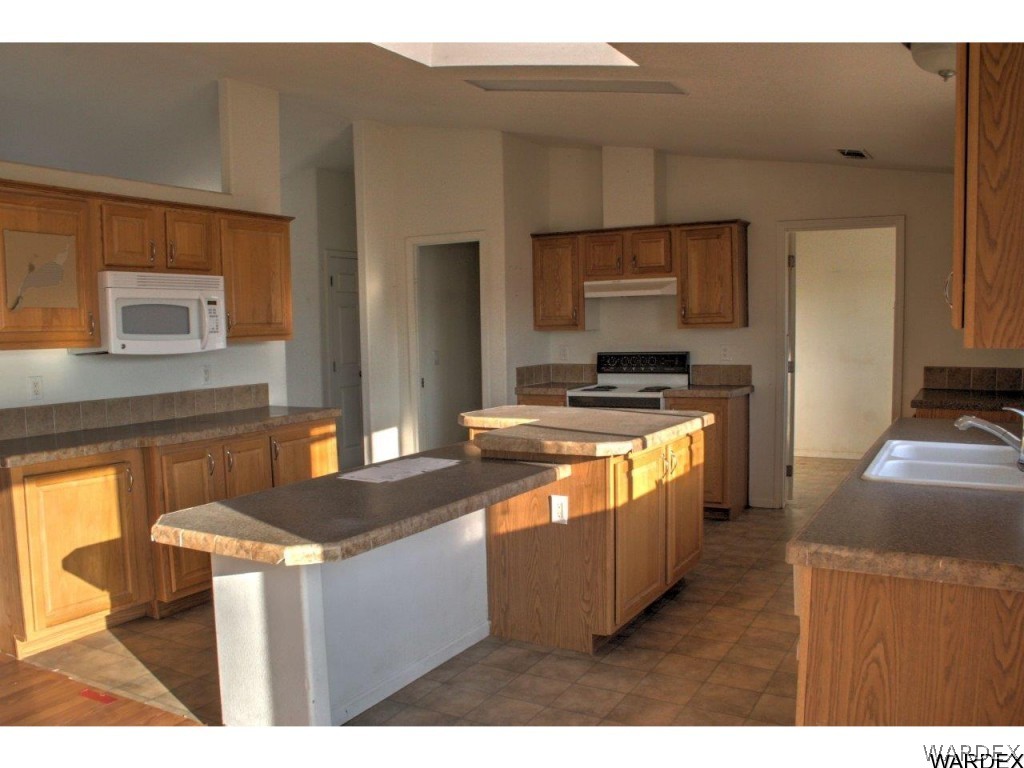 3969 Elfrida Road Golden Valley, AZ 86413 - Photo 18 of 29 a kitchen with stainless steel appliances granite countertop a stove a sink and a refrigerator