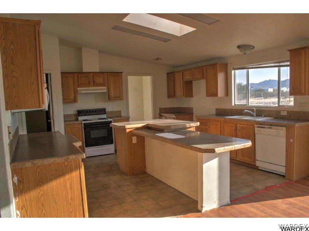 3969 Elfrida Road Golden Valley, AZ 86413 - Photo 19 of 29 a kitchen with a sink stove and refrigerator