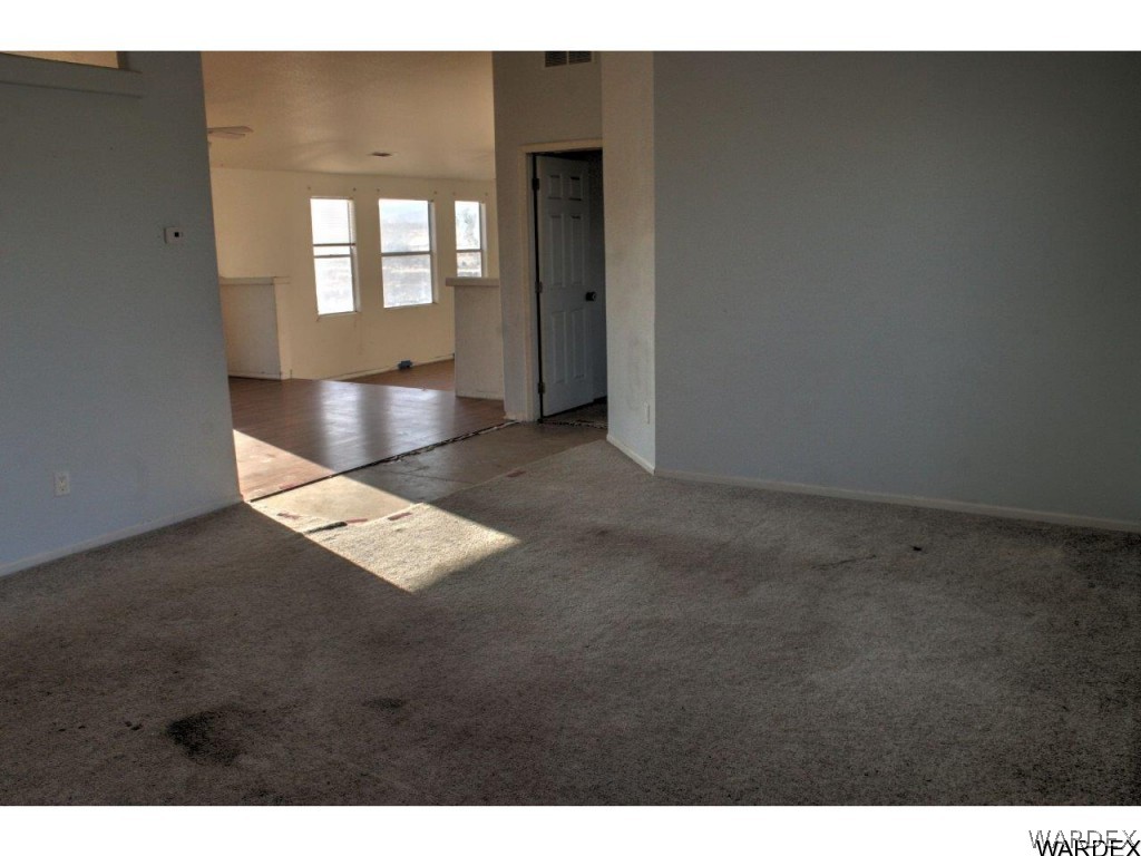 3969 Elfrida Road Golden Valley, AZ 86413 - Photo 2 of 29 a view of an empty room with wooden floor and a living room
