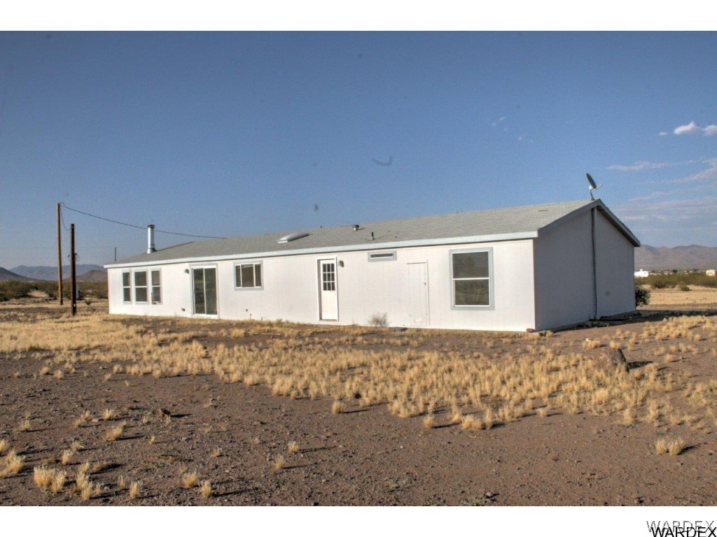 3969 Elfrida Road Golden Valley, AZ 86413 - Photo 22 of 29 a view of a house with a backyard