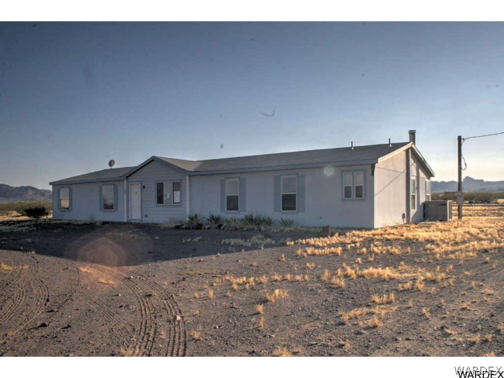 3969 Elfrida Road Golden Valley, AZ 86413 - Photo 28 of 29 a view of a house with a dirt road and a road