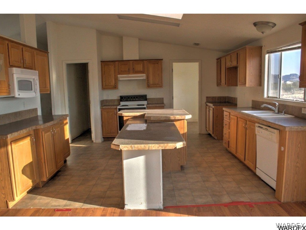 3969 Elfrida Road Golden Valley, AZ 86413 - Photo 4 of 29 a kitchen with stainless steel appliances granite countertop a stove a sink dishwasher and a refrigerator