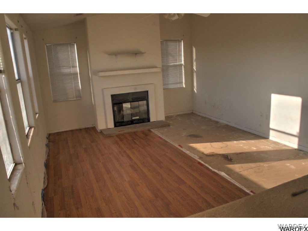 3969 Elfrida Road Golden Valley, AZ 86413 - Photo 7 of 29 a view of empty room with wooden floor and fireplace