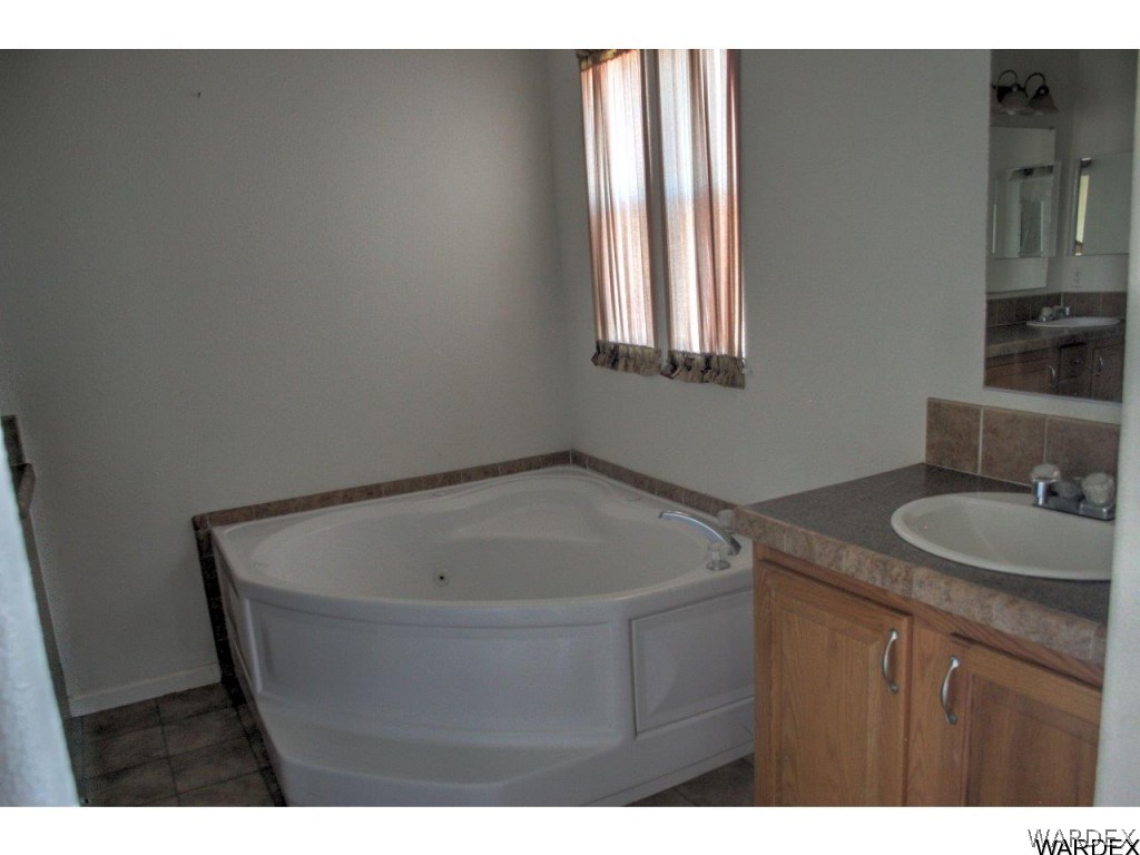 3969 Elfrida Road Golden Valley, AZ 86413 - Photo 10 of 29 a bathroom with a sink and a mirror