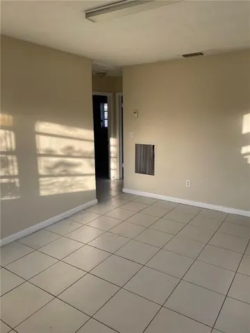 a view of an empty room and a window