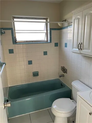 a bathroom with a toilet a sink and bathtub