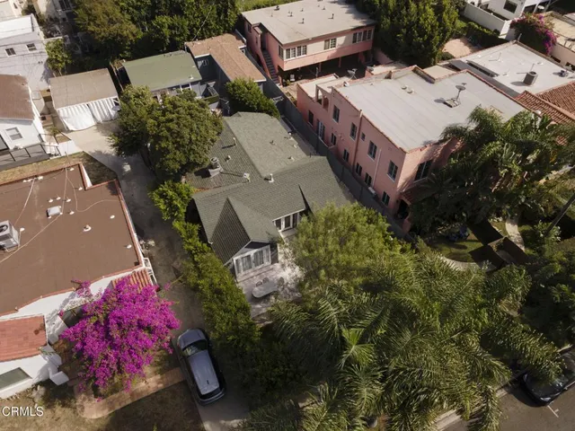 an aerial view of a house with a yard
