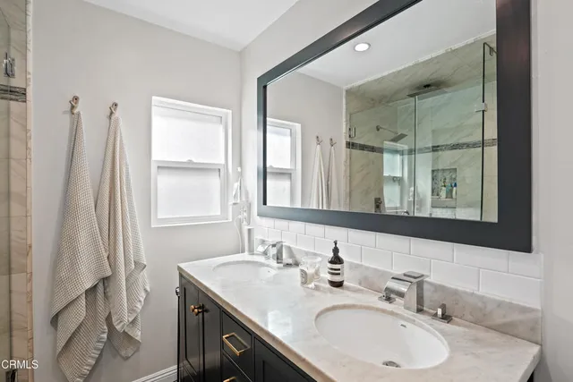 a bathroom with a sink double vanity and a mirror