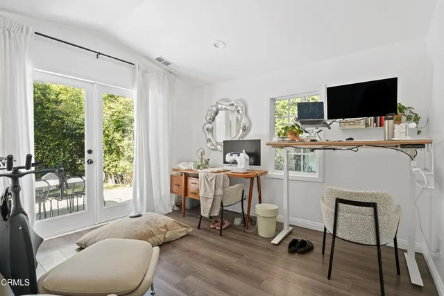 a view of a livingroom with furniture and a flat screen tv