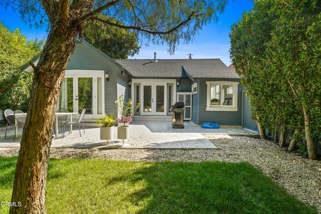 a view of a house with backyard and sitting area