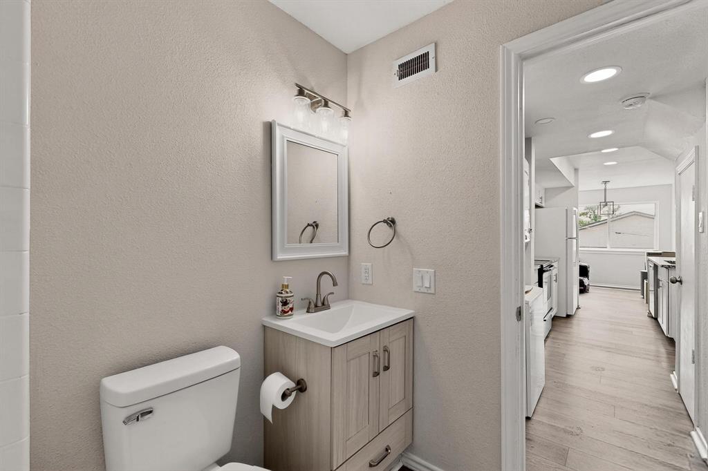 9809 Walnut Street, Unit E209 Dallas, TX 75243 - Photo 20 of 31 a bathroom with a sink toilet and shower