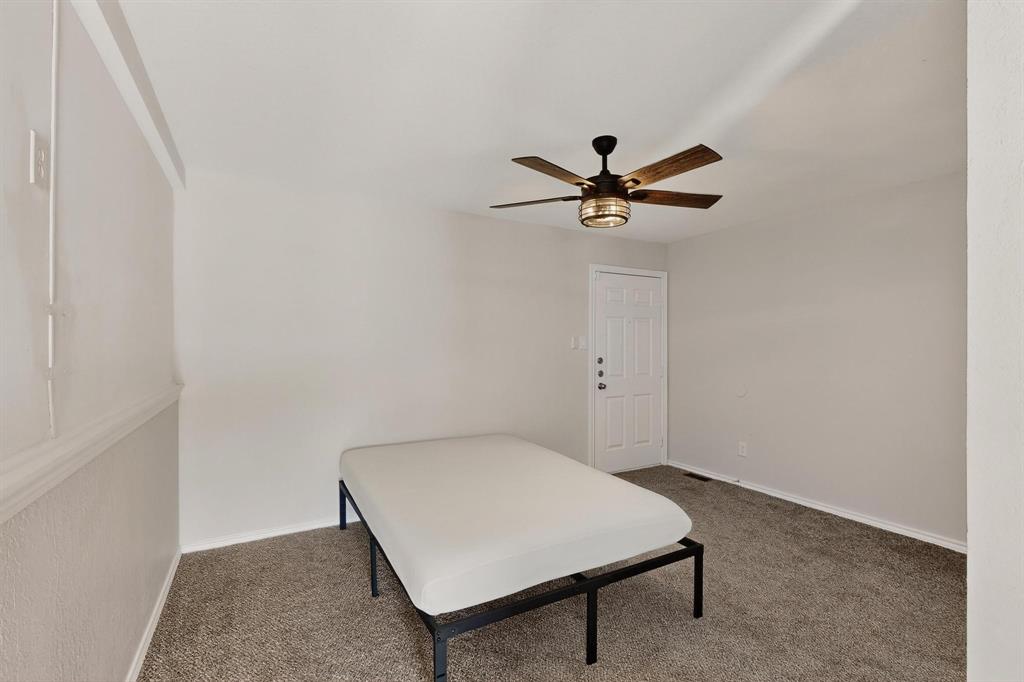 9809 Walnut Street, Unit E209 Dallas, TX 75243 - Photo 22 of 31 a room with a table and a ceiling fan