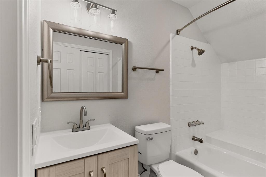 9809 Walnut Street, Unit E209 Dallas, TX 75243 - Photo 24 of 31 a bathroom with a sink a toilet and shower