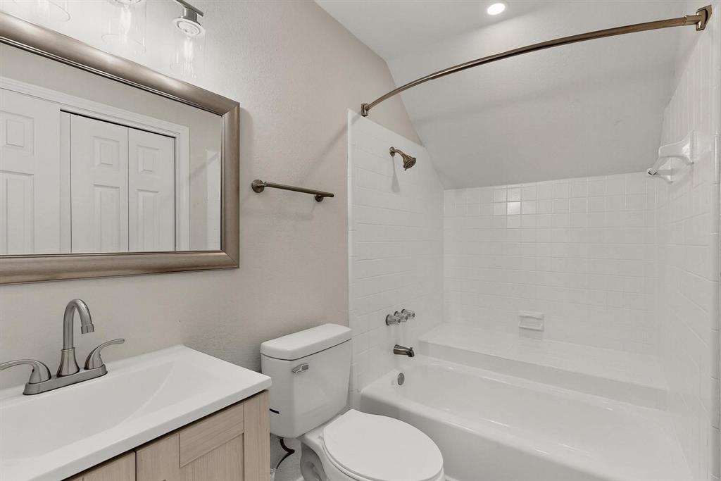 9809 Walnut Street, Unit E209 Dallas, TX 75243 - Photo 25 of 31 a bathroom with a sink toilet and shower