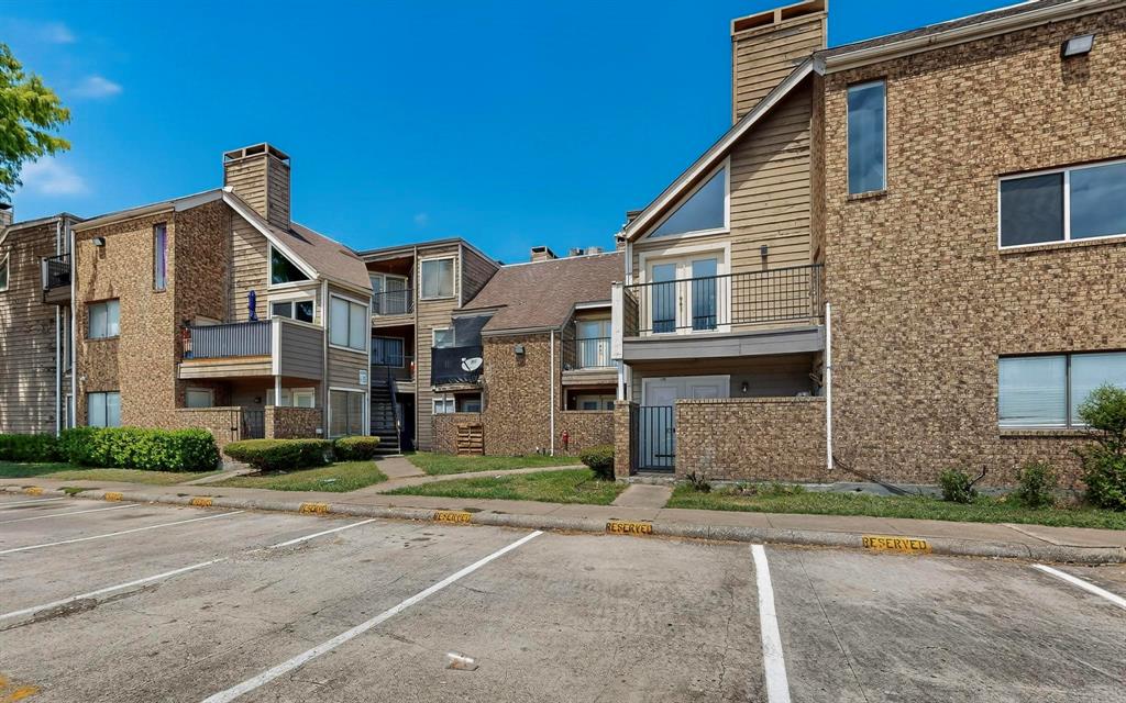 9809 Walnut Street, Unit E209 Dallas, TX 75243 - Photo 3 of 31 a front view of a house with a yard