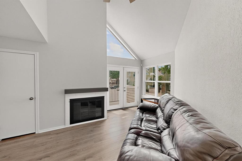 9809 Walnut Street, Unit E209 Dallas, TX 75243 - Photo 31 of 31 a living room with furniture a window and a fireplace
