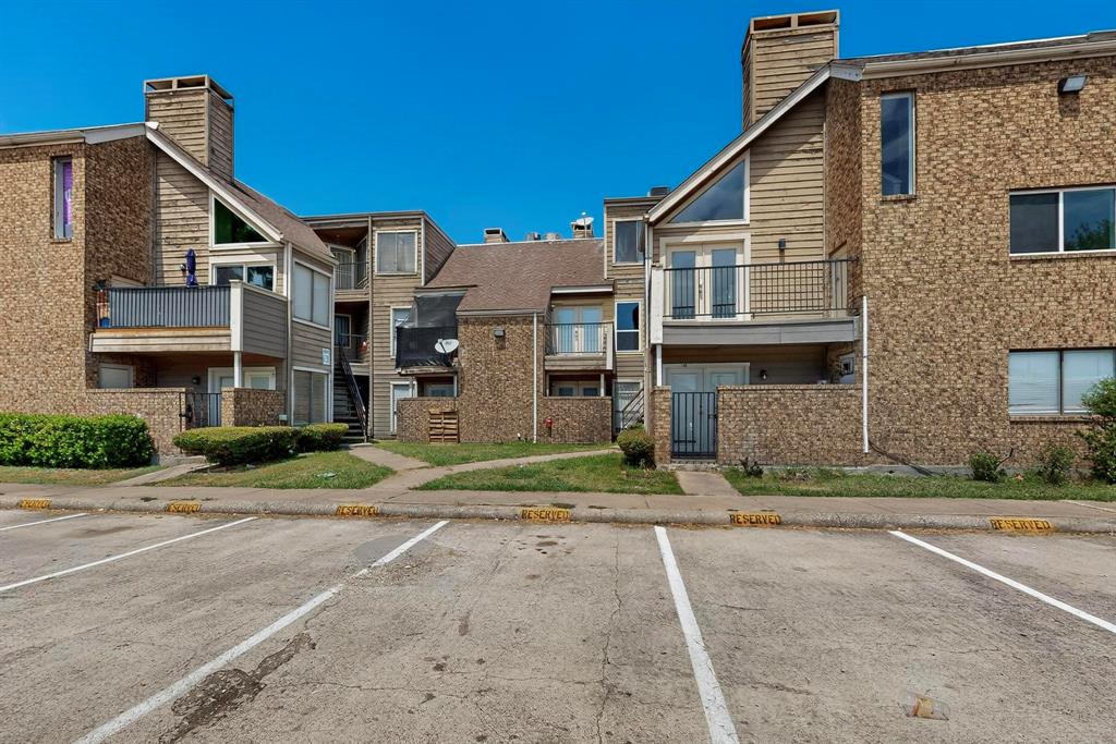 9809 Walnut Street, Unit E209 Dallas, TX 75243 - Photo 4 of 31 a front view of a house with a yard