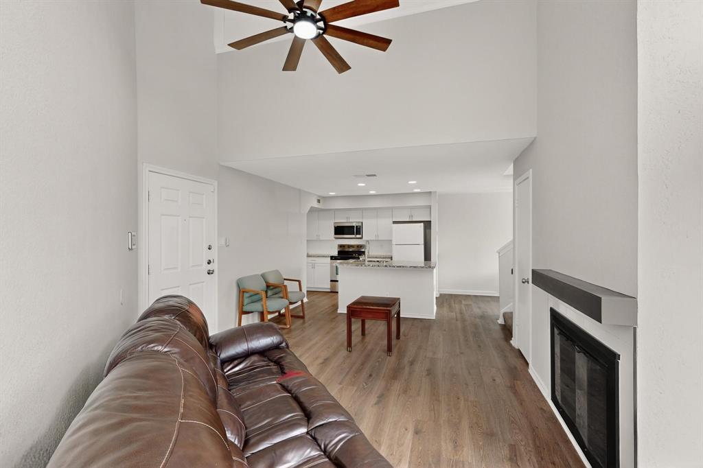 9809 Walnut Street, Unit E209 Dallas, TX 75243 - Photo 10 of 31 a living room with furniture and a fireplace