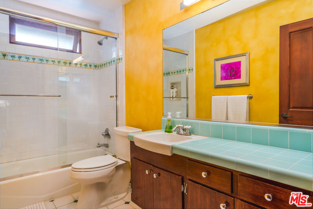 3643 Oceanhill Way Malibu, CA 90265 - Photo 15 of 28 a bathroom with a granite countertop sink a toilet and shower
