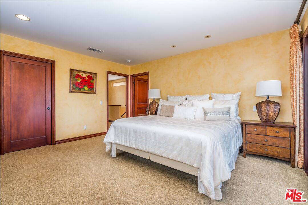 3643 Oceanhill Way Malibu, CA 90265 - Photo 17 of 28 a spacious bedroom with a bed and a painting on the wall