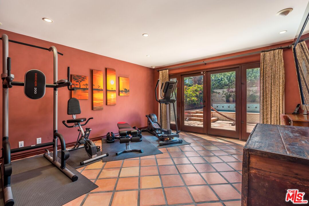 3643 Oceanhill Way Malibu, CA 90265 - Photo 20 of 28 a room with gym equipment and floor to ceiling window