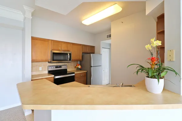 a kitchen with a refrigerator a stove and a sink