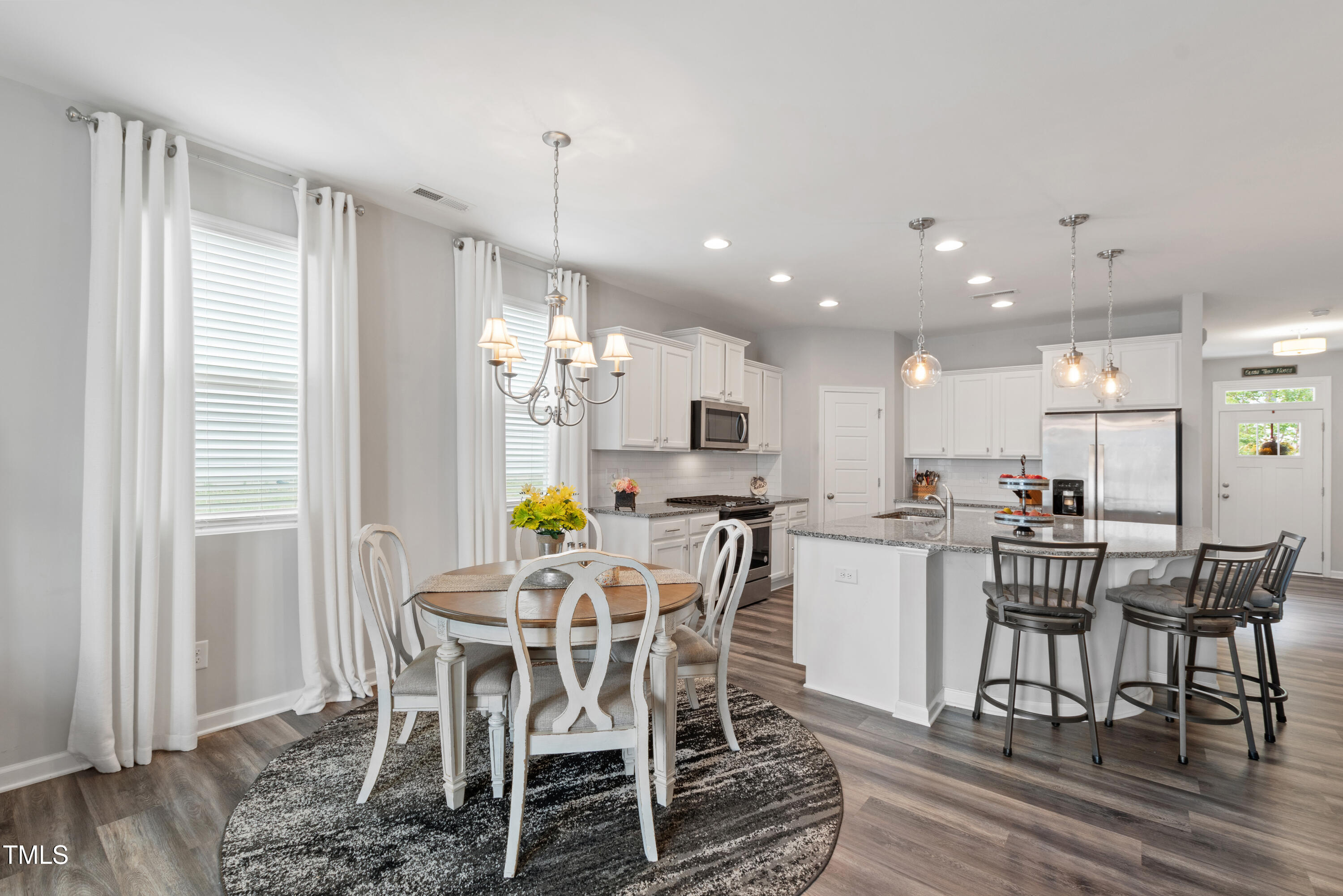 321 Everly Mist Way Wake Forest, NC 27587 - Photo 13 of 38 a view of a dining room with furniture window and wooden floor