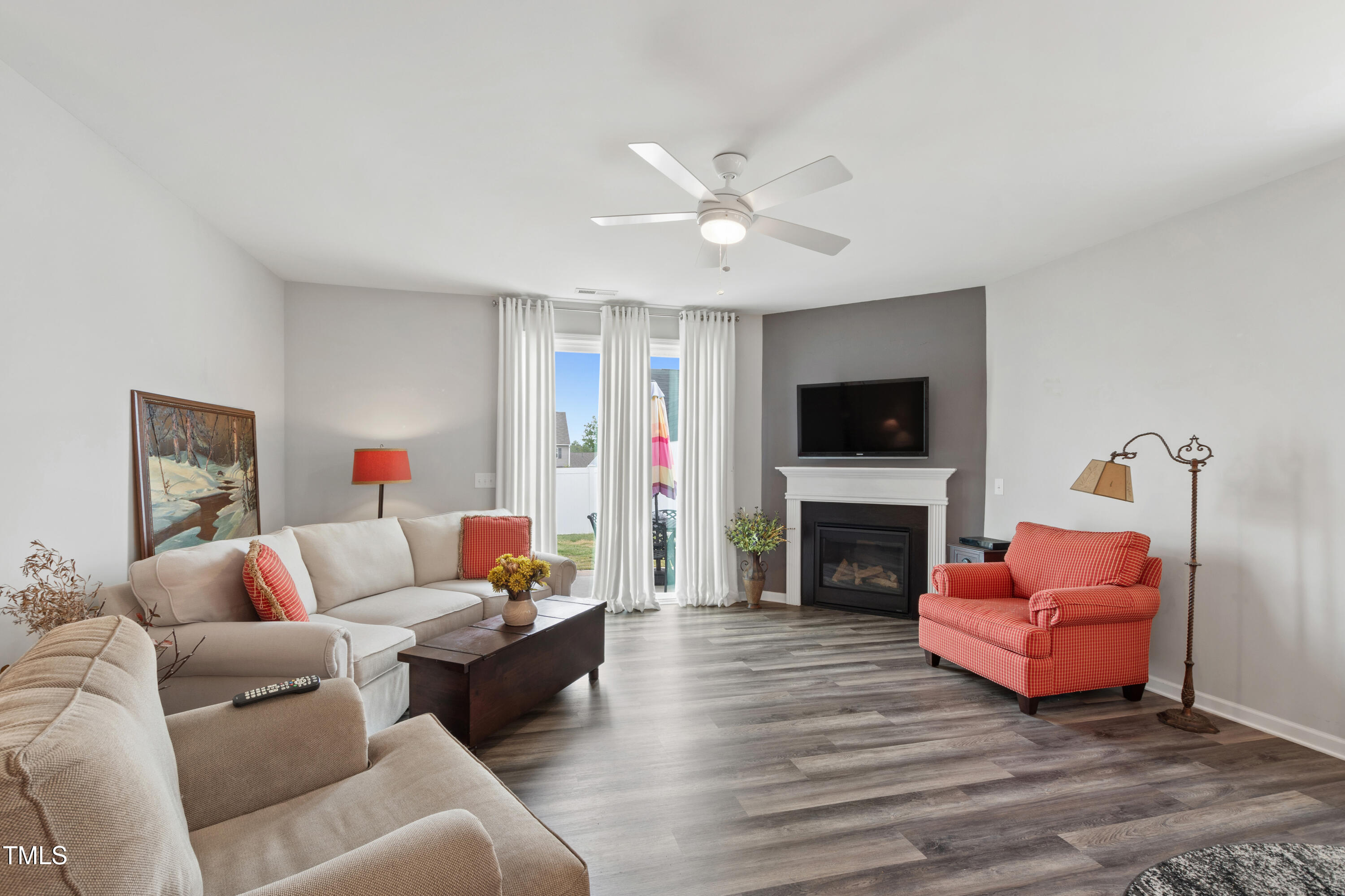 321 Everly Mist Way Wake Forest, NC 27587 - Photo 14 of 38 a living room with furniture a fireplace and a flat screen tv