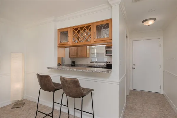 a kitchen with a stove a refrigerator a sink and a window