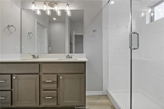 a bathroom with a sink vanity and a mirror