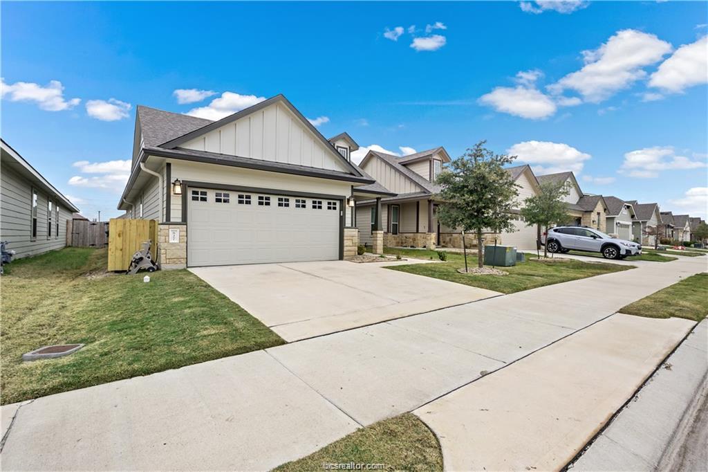 827 Mineral Wells Lane College Station, TX 77845 - Photo 2 of 23 a front view of a house with a yard
