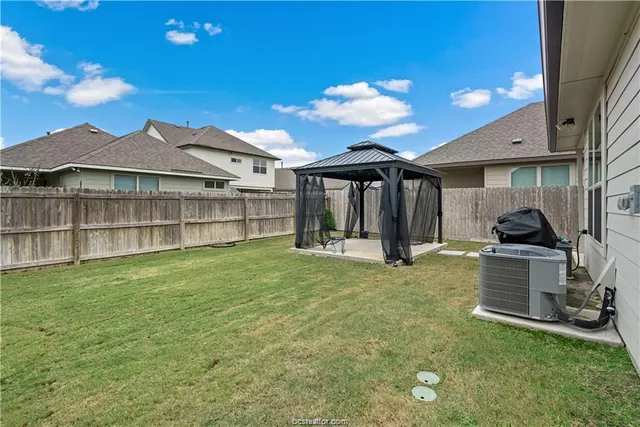 a view of a house with backyard porch and sitting area