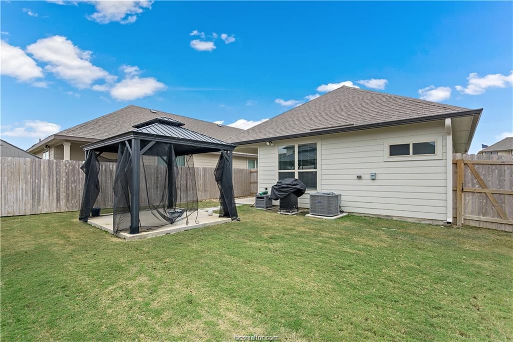 827 Mineral Wells Lane College Station, TX 77845 - Photo 22 of 23 a view of a house with backyard and porch