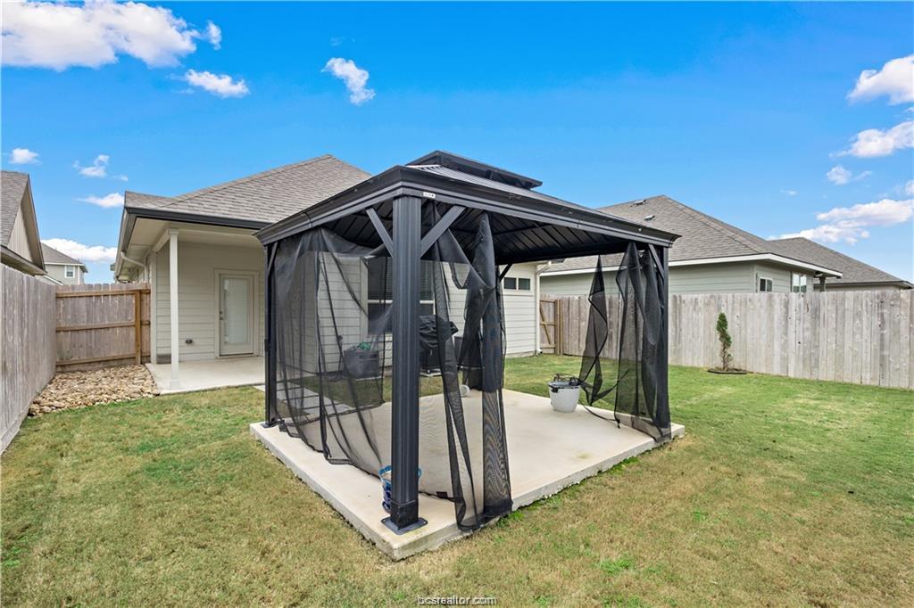 827 Mineral Wells Lane College Station, TX 77845 - Photo 23 of 23 a view of a house with a small yard and a large tree